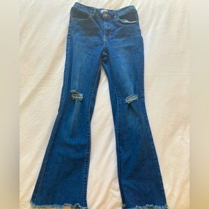 Ripped flared blue jeans